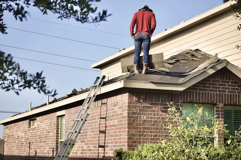 Professional roofer working on a residential roof in Kingston Shores